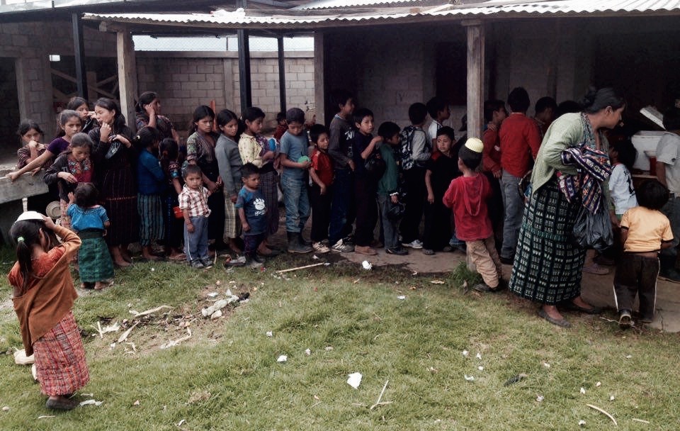 RHI's Feeding Center Photo Challenge: How many kids in this photo do you see wearing their bowls on their heads?